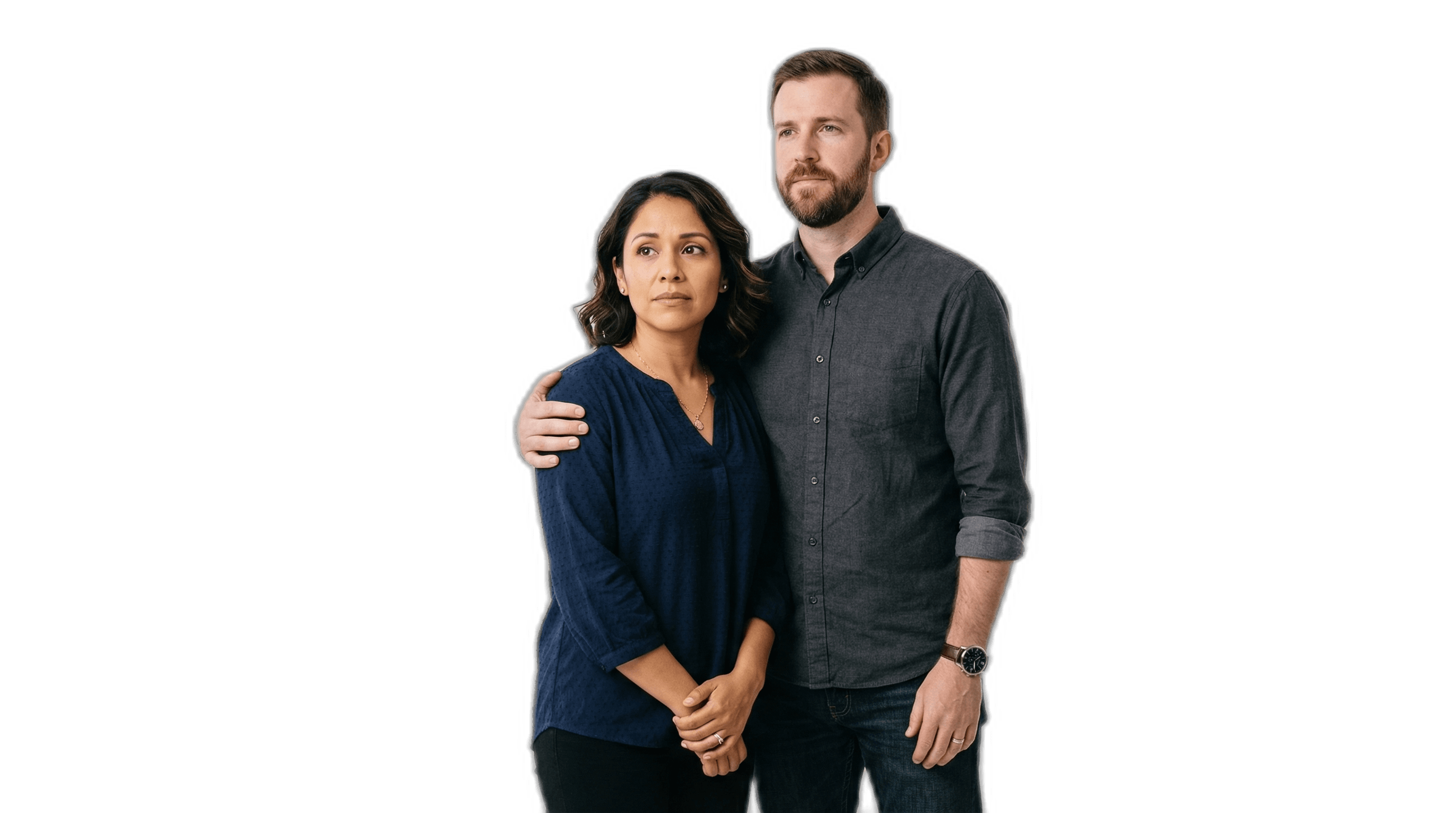 Concerned mixed-ethnicity couple standing together, the man with a protective arm around the woman's shoulder.