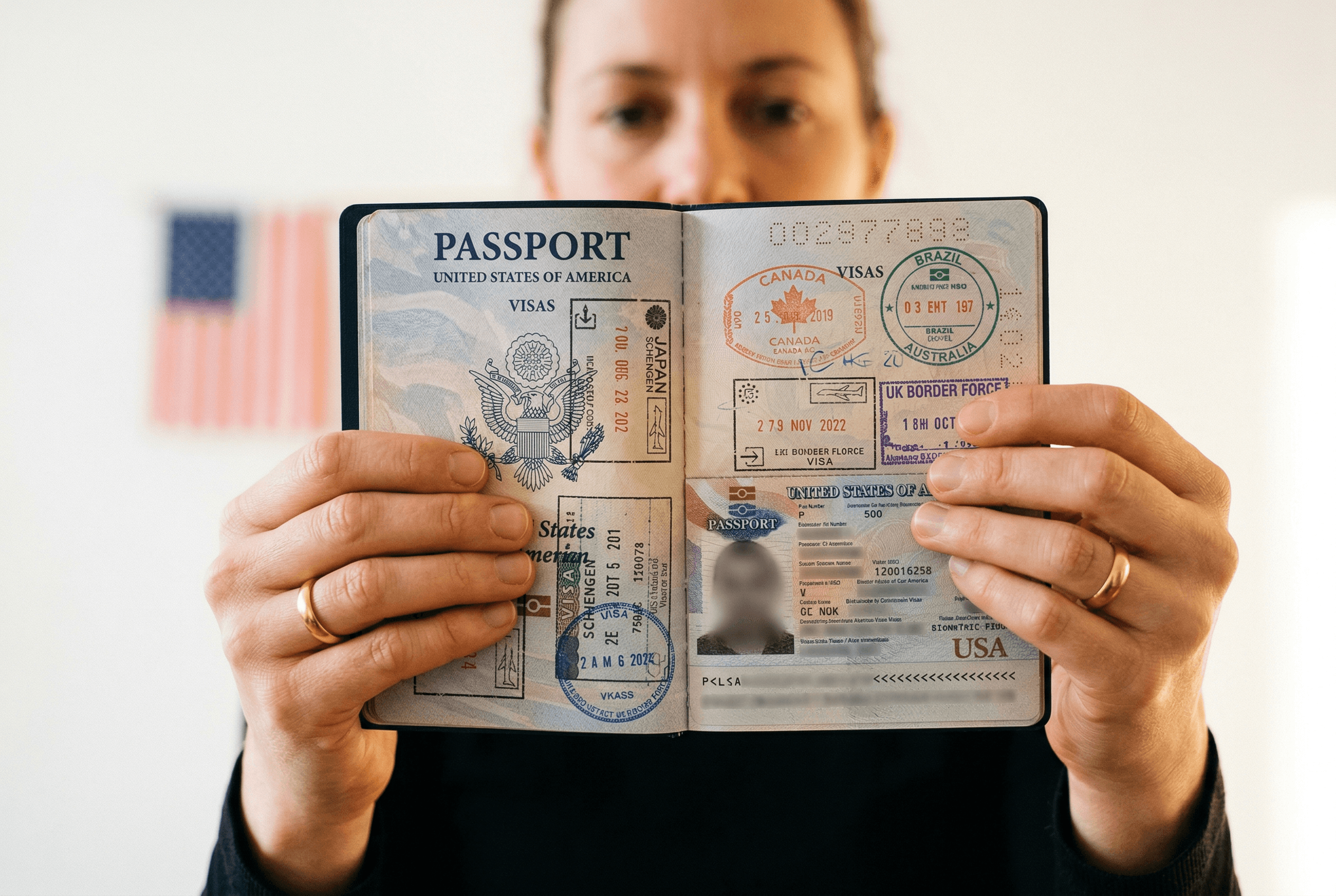 Military spouse holding open U.S. passport with visa stamps